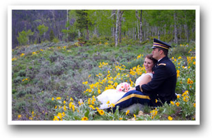 Colorado Wedding couple sitting in a field of wild flowers
