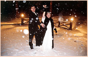 Just married couple celebrating in the snowflakes in Colorado
