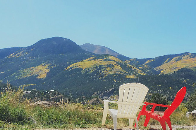 Chairs at Alpine Moose Lodge overlooking view of San Juan Mountains near Lake City, Colorado