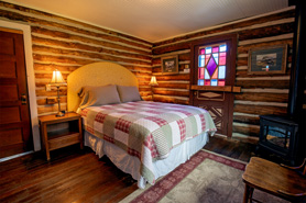 Inside view of Hortense Cabin with queen bed at Antero Hot Springs Cabins in Buena Vista, Colorado.