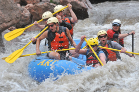A group of people whitewater rafting on the Arkansas River near the Royal Gorge and Salida, Colorado. Experience the Thrill of Whitewater Rafting with Arkansas River Tours.