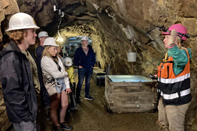 Tourists listening to tour guide at Capital Prize Gold Mine in Georgetown, Colorado.