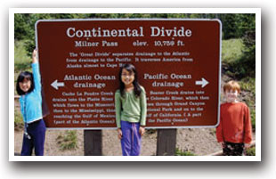 Hikers posing in front of The Continental Divide sign, Colorado.