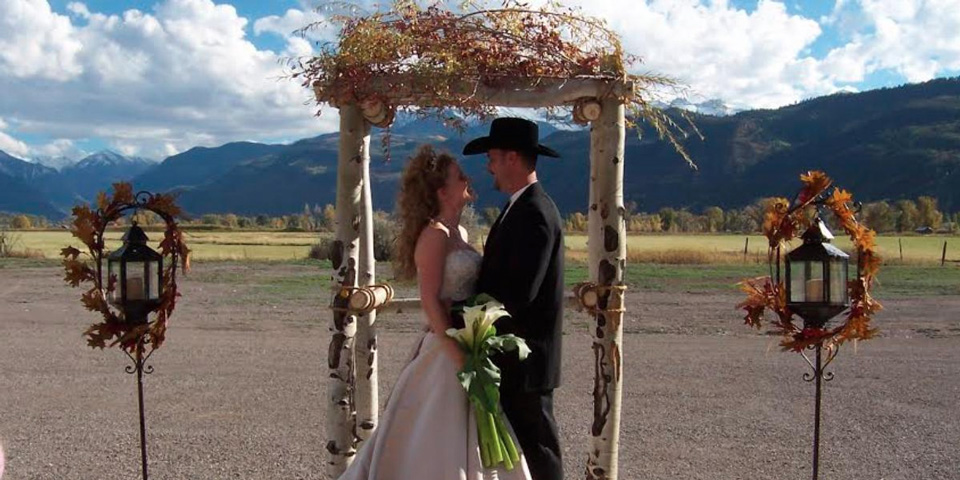 Couple getting married at the Ouray Country 4-h Event Center in Colorado with mountains in the background