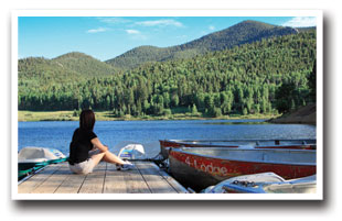 Woman siting on boat dock at Lake San Isabel in Colorado