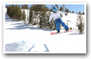 Snowboarder jumping at Granby Ranch Ski Resort, Colorado.
