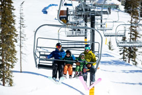 Family riding up the chair lift at Monarch Mountain Ski and Snow-Boarding Resort, Colorado. Photo Courtesy of Creekside Chalets and Cabins.