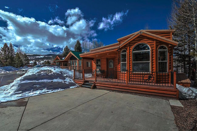A cabin covered in snow at the Tiger Run Resort: Chalets & RV Park in Summit County Colorado