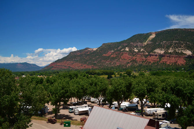 Aerial view of United Campground with swimming pool in Durango, Colorado. Best Photographs of Train as it Runs Through United Campground. Deluxe Camping. Recreation on the North Edge of Durango. Animas River Borders Park. Gorgeous Views of the Nearby Red Cliffs.