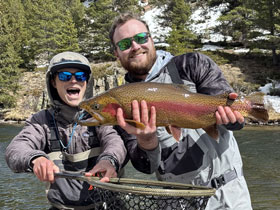 Fisherman showing off his caught rainbow trout with Three Rivers Resort and Outfitting in Gunnison, Colorado. Orvis Fly Shop. Guided Fly-Fishing Outfitting.