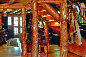 Interior of Allenspark Lodges Great Room with rustic log furnishings in Allenspark, Colorado.