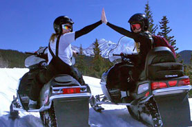 Snowmobiler's high-fiving during a tour with All Season Adventures, Inc. near Salida, Colorado.