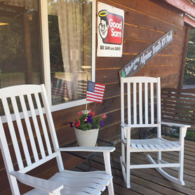 Inviting seating area on front porch at Alpine Trails RV Park, Cabin and Jeep Rentals in South Fork, Colorado