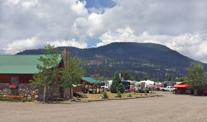 View of cabin and RV sites at Alpine Trails RV Park and Cabins in South Fork, Colorado