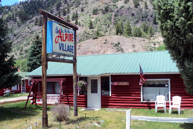 Welcome sign at Alpine Village Historic Log Cabin Rentals in Lake City, Colorado.
