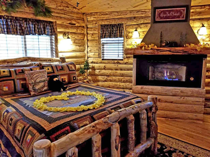 A large cozy bedroom with fireplace at Annies Mountain Retreat and Guest House in Estes Park, Colorado