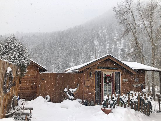 Cabin in a snowy winter wonderland at Annies Mountain Retreat and Guest Resort in Estes Park, Colorado
