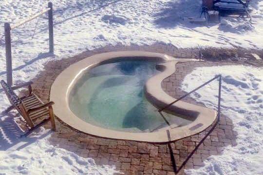 Private hot springs soaking pool in the winter at Antero Hot Springs Cabins in the Buena Vista Area, Colorado.