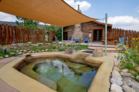 Hortense Cabin hot springs pool under a canopy at Antero Hot Springs Cabins in the Buena Vista Area, Colorado.