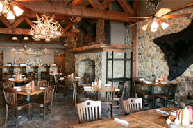 View of dining area with stone fireplace at the River Rock Cafe near North Park in Walden, Colorado
