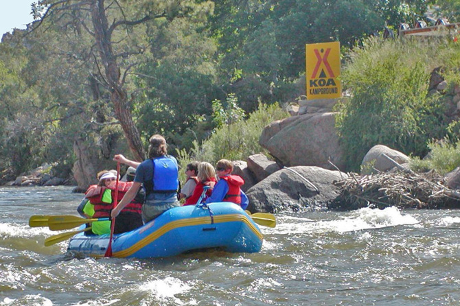 A raft of people rafting on the Arkansas River near the Arkansas River KOA, Loma Linda Motel near Royal Gorge.