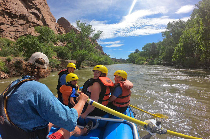 Family floating down the Arkansas River on a whitewater rafting tour with Arkansas River Tours near the Royal Gorge and Salida, Colorado.