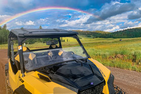 ATV-UTV rental on trail in the Uncompahgre National Forest under a rainbow near Arrowhead Mountain Lodge, Restaurant and Bar in Cimarron, Colorado.