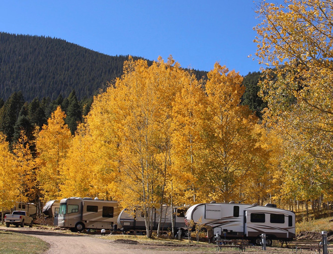 RV camping sites with full hookups and picnic benches during the fall at Aspen Acres Campground located within the Greenhorn Valley in Rye, Colorado.