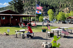 Picnic table area near RV sites and recreation hall at Aspen Ridge RV Park in South Fork, Colorado