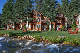 Exterior of Aspen Winds on Fall Riverin the spring with Fall River in fore ground