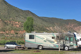 An RV and car at Aunt Sara's River Dance RV Resort in Gypsum, Colorado near Vail.