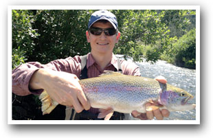 Jim Rowe holding up a caught fish near Fort Collins, Colorado