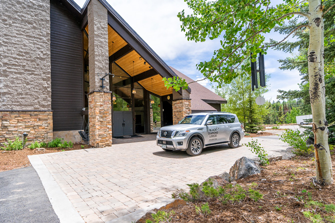 SUV parked in driveway entrance to lodge at Black Diamond Lodge located in Durango, Colorado.