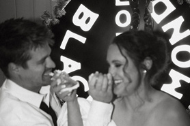 Couple at wedding reception sharing wedding cake at Black Diamond Lodge located in Durango, Colorado.