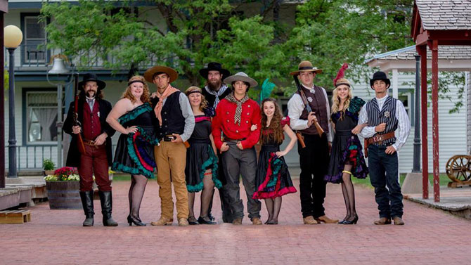 A cast of wild west gunslingers and cancan dancers on the street of Burlington Old Town Museum a old western town in Eastern Colorado