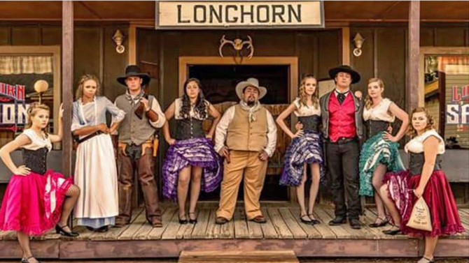 A cast of wild west gunslingers and cancan dancers on the street of Burlington Old Town Museum a old western town in Eastern Colorado. SUMMER FUN. Hand Dipped Ice Cream Treats. Horse-Drawn Wagon Rides. Cancan and Gunfight Shows. In the Heart of Colorado's Central Plains.