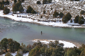Birdseye view of fisherman during the winter in the Chama River near Rio Chama, New Mexico