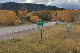 Welcome to Chama sign with Fall colors in the background at Chama, New Mexico