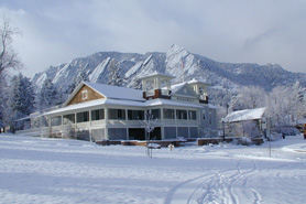 Dining commons in snow with mountains behind in Boulder Colorado. On-site dining featuring organic colorado cuisine.