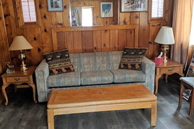 Fully furnished living room inside cabin at Columbine Cabins in Grand Lake, Colorado