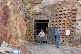 Miners talking at the tunnel entrance to Last Chance Mine in Creede, Colorado.