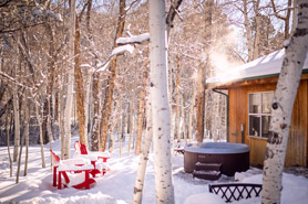 Private outdoor hot tub in the winter at Creekside Chalets and Cabins: Year-Round Quality Vacation Rentals in Salida, Colorado.