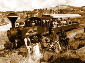 Family posing in front of the Historic Cripple Creek and Victor Narrow Gauge Railroad in Cripple Creek, Colorado.