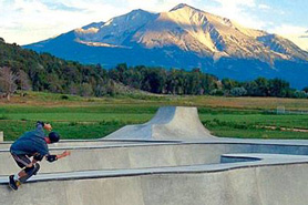 Skate boarder at skate park with Mt. Sopris in the background in Carbondale, Colorado.