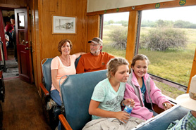 Family enjoying a scenic ride in the Coach Car on the Cumbres and Toltec Train between Antonito, Colorado and Chama, New Mexico.