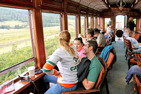People enjoying drinks with amazing views in the Parlor Car along the Cumbres and Toltec Scenic Railroad between Antonito, Colorado and Chama, New Mexico.