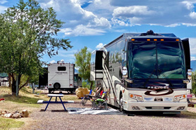 Big rig RV sites with fire pits and picnic tables at Farmhouse RV Resort in Royal Gorge, Colorado