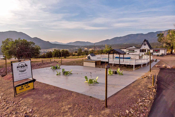 Arial view of furnished patio, outdoor pool and office at Farmhouse RV Resort in Royal Gorge, Colorado