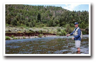 Fisherman casting his rod at the Rio Blanco County Access area near Buford, Colorado