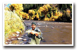 Fly fisherman showing off his catch from Turkey Creek near Pagosa Springs, Colorado